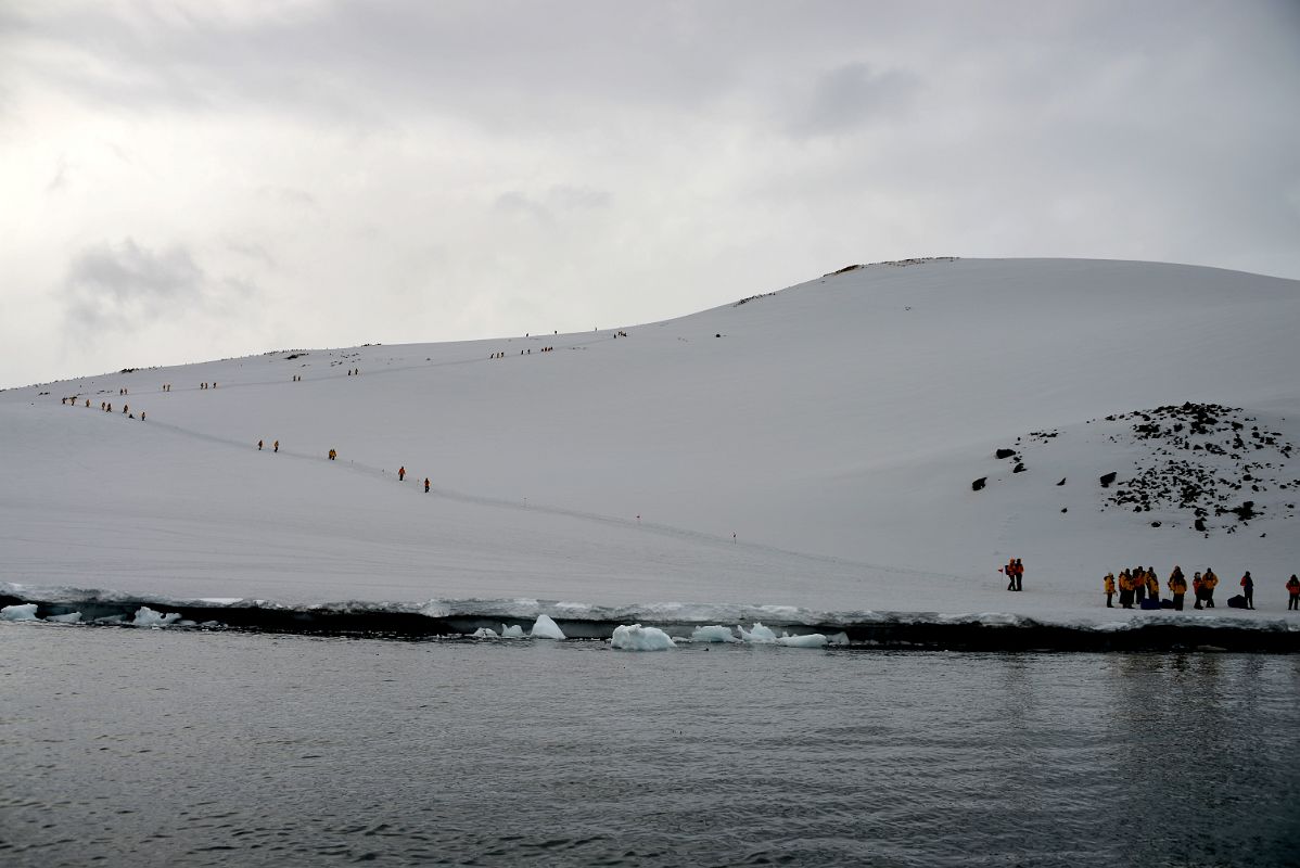 09C Zodiac About To Land On Danco Island With Tourists Climbing To The Top Of The Island On Quark Expeditions Antarctica Cruise